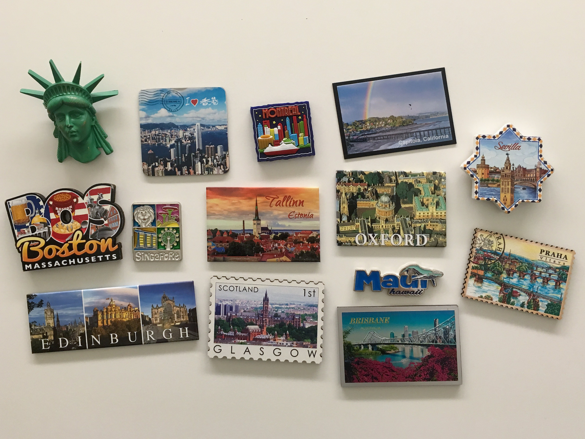A collection of magnets commemorating different locations.